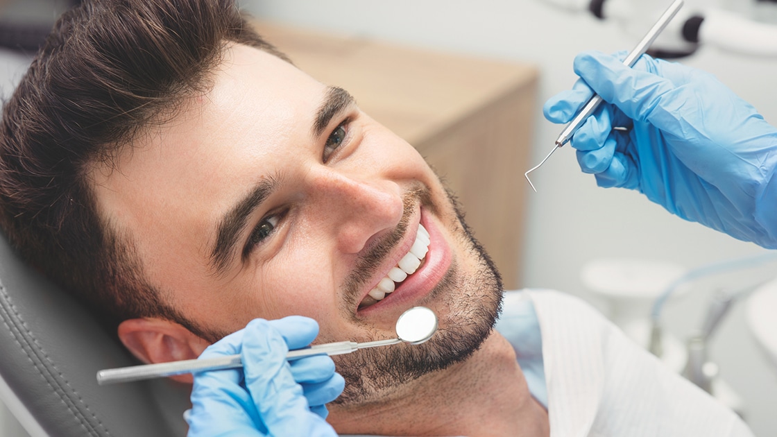 Man Smiling in Dental Chair